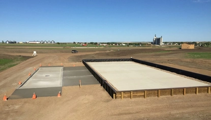 Aerial view of a concrete load pad and lined containment area at an industrial site, designed for loading operations and spill control.